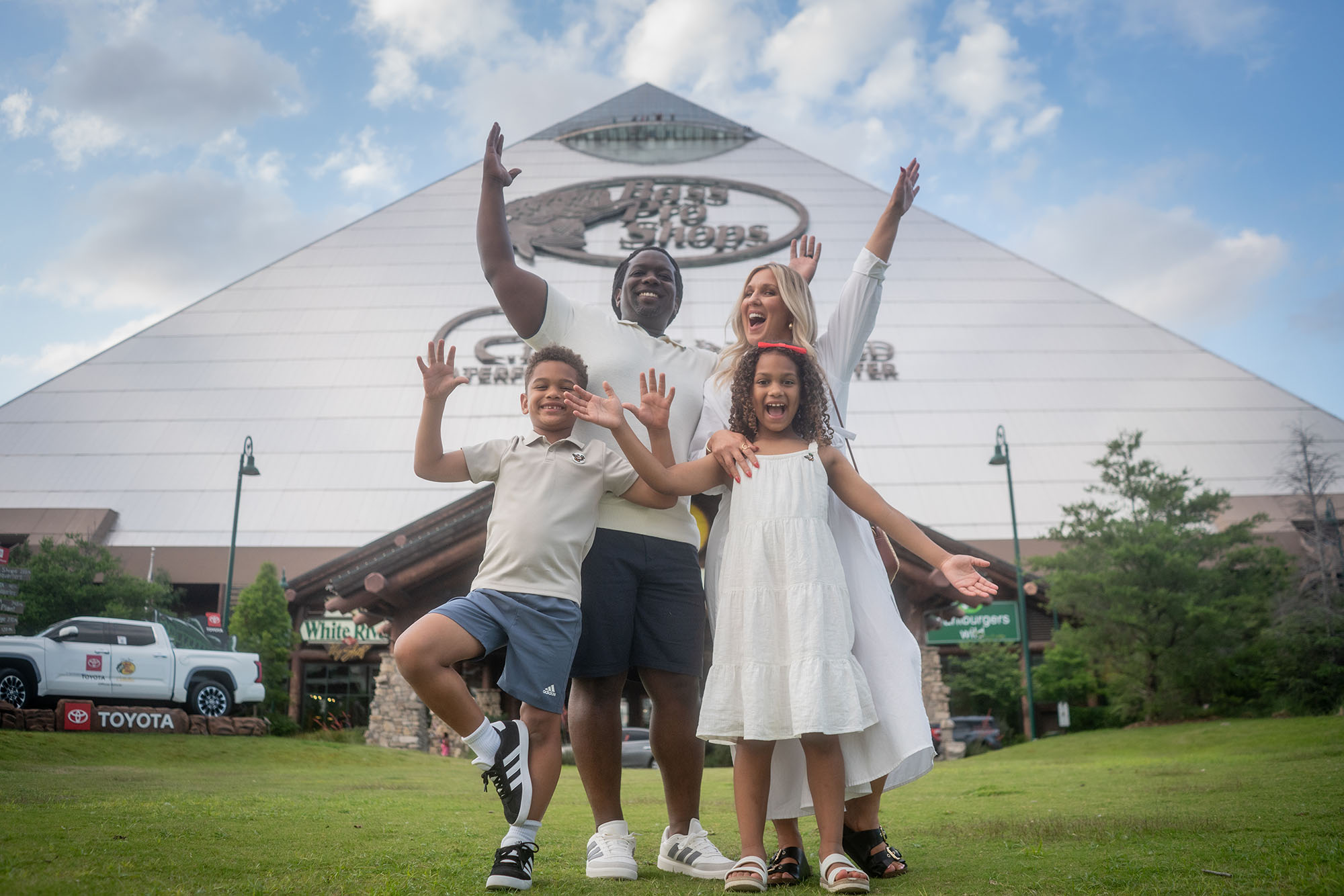 Family stands outside in front of Bass Pro Shops at the Pyramid.