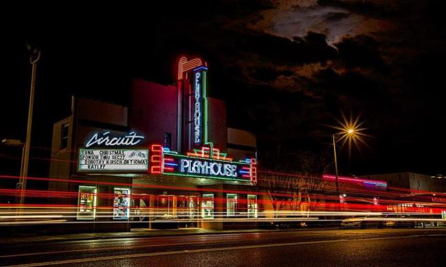 exterior photo of circuit playhouse at night with neon lights glowing