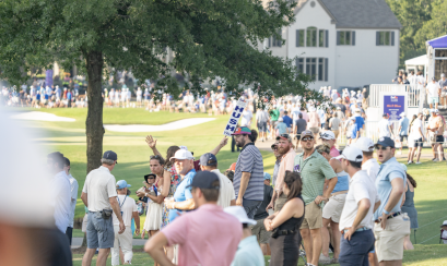 spectators line golf course at tournament