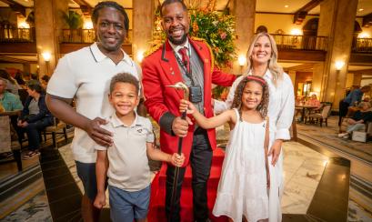 family of four poses with peabody duck master