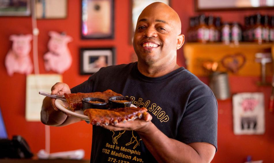 Owner Eric Vernon showcases a platter of ribs at his Midtown Memphis restaurant, The Bar-B-Q Shop