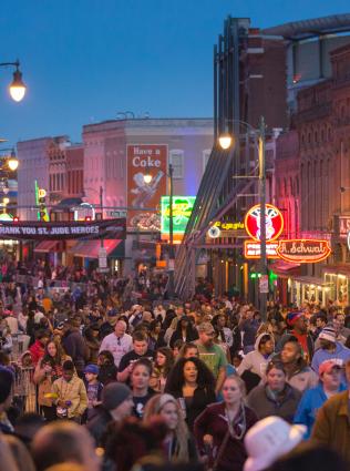 People out at night on Beale Street in Memphis