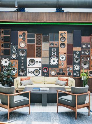 couch sits in front of stereo designed wall at central station