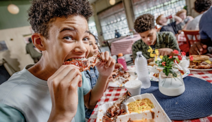 boy eats rib at payne's